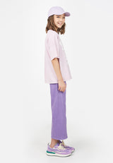 Side view of model wearing Teen Lavender Varsity T-Shirt by Gen Woo. 
