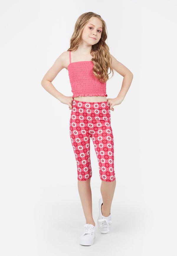 Teenage girl wears the Pink Checkerboard Retro Floral Print Girls Leggings by Gen Woo
