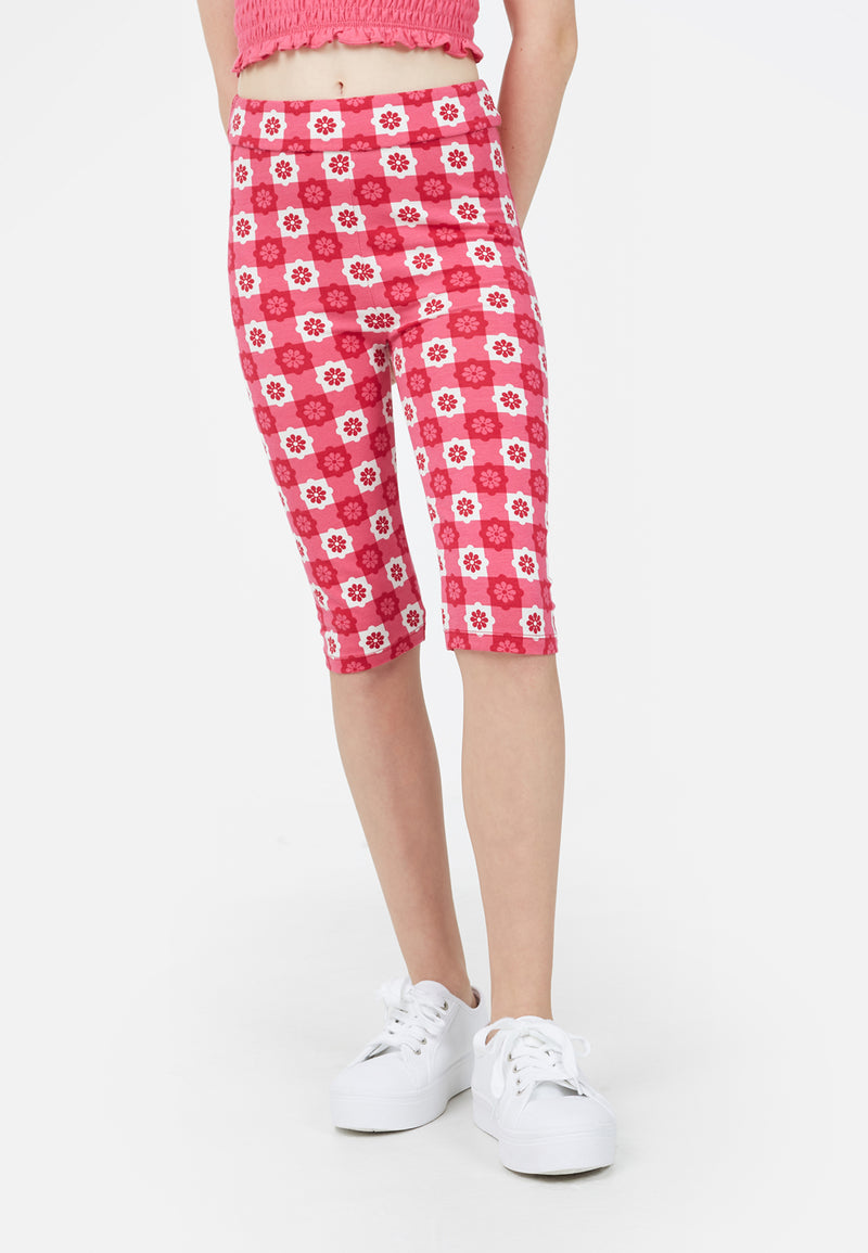 Close-up of the teenage girl in the Pink Checkerboard Retro Floral Print Girls Leggings by Gen Woo