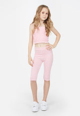 Teenage girl wears the Pink Gingham Print Girls Leggings by Gen Woo