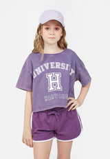 Model wears boxy Teen Violet Varsity Crop T-Shirt by Gen Woo. 