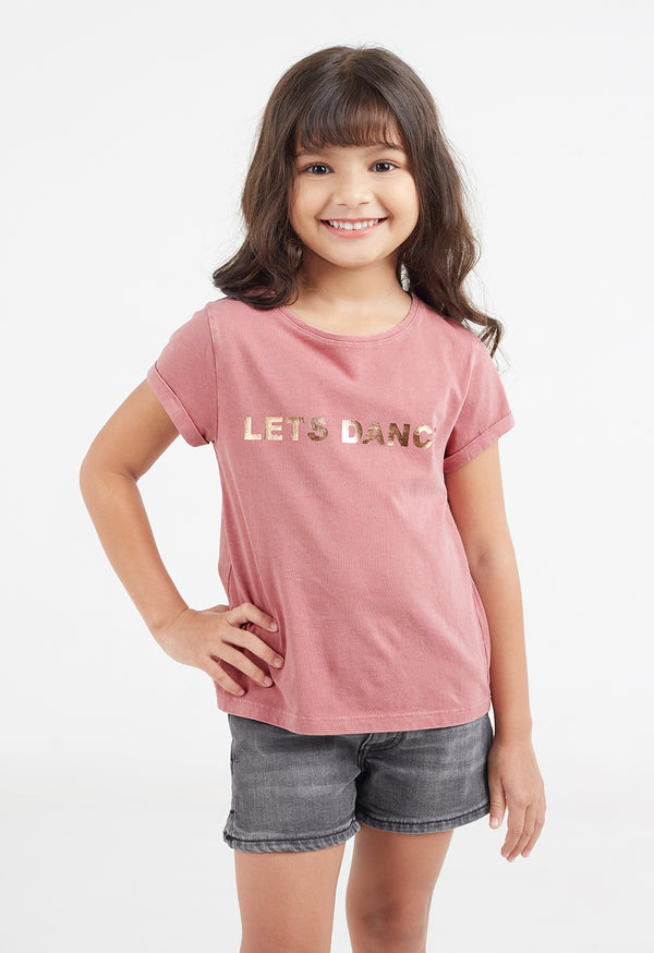 Close-up of the young girl wearing the “Let’s Dance” Girls Gold Foil Slogan T-Shirt by Gen Woo