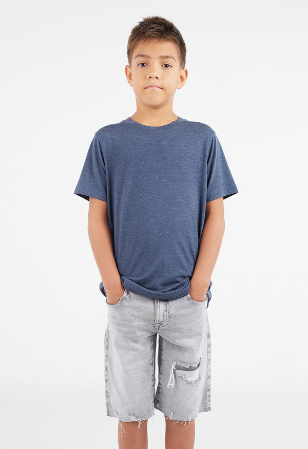 The young boy wears the Boys Classic Crew Neck Navy T-Shirt by Gen Woo