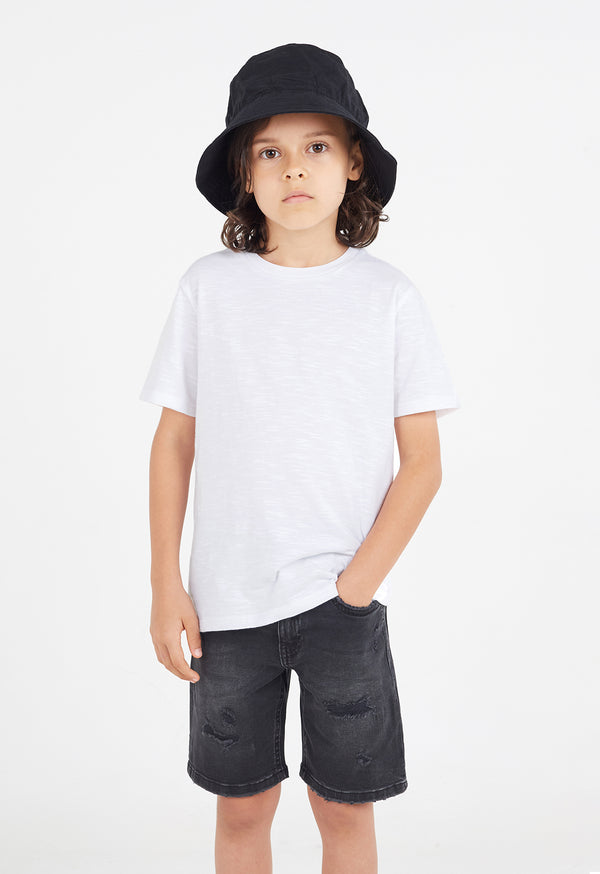 The young boy wears the Boys Classic Crew Neck White T-Shirt by Gen Woo