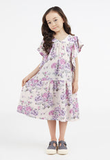 The young girl wears the Pink and Purple Floral Bloom Tiered Girls Dress by Gen Woo