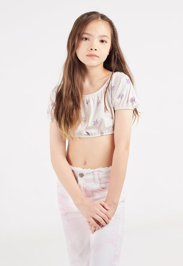 The young girl wears the Girls Off-The-Shoulder Ditsy Crop Top by Gen Woo