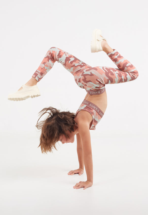 The young girl does a handstand pose wearing the Pink Camo Print Girls Leggings by Gen Woo