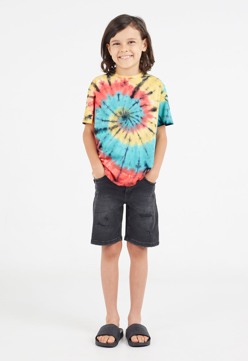 The young boy wears the Boys Multicolour Spiral Tie-Dye T-Shirt by Gen Woo with denim shorts and slides