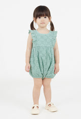 The young girl wears the Mint Broderie Cotton Baby Romper by Gen Woo