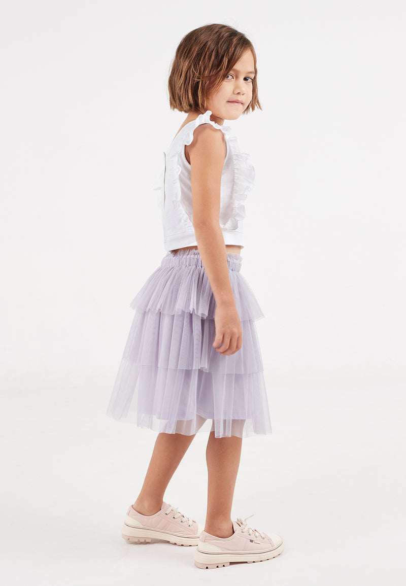 The young girl pairs the Purple Mesh Tiered Knee-Length Girls Skirt by Gen Woo with a white cropped top