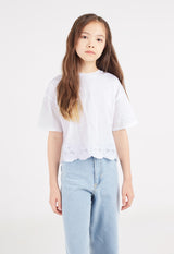 The teen girl wears the White Broderie Trim Girls T-Shirt by Gen Woo
