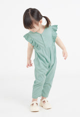 The young girl poses wearing the Mint Broderie Trim Long Leg Romper by Gen Woo