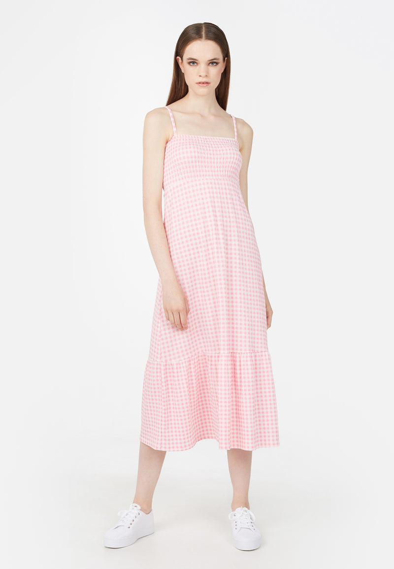 The model wears the Pink Gingham Ladies Maxi Dress by Gen Woo