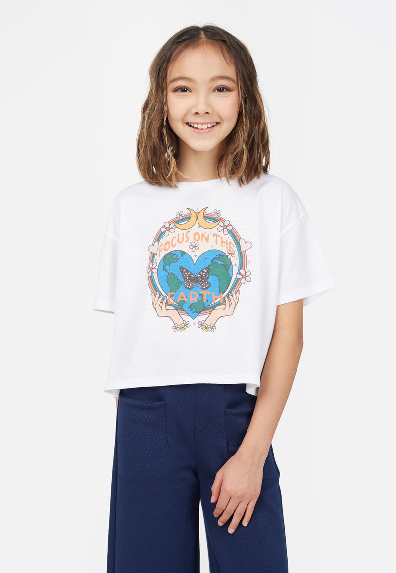 The young girl wears the “Focus on the Earth” Cropped Graphic Tee by Gen Woo