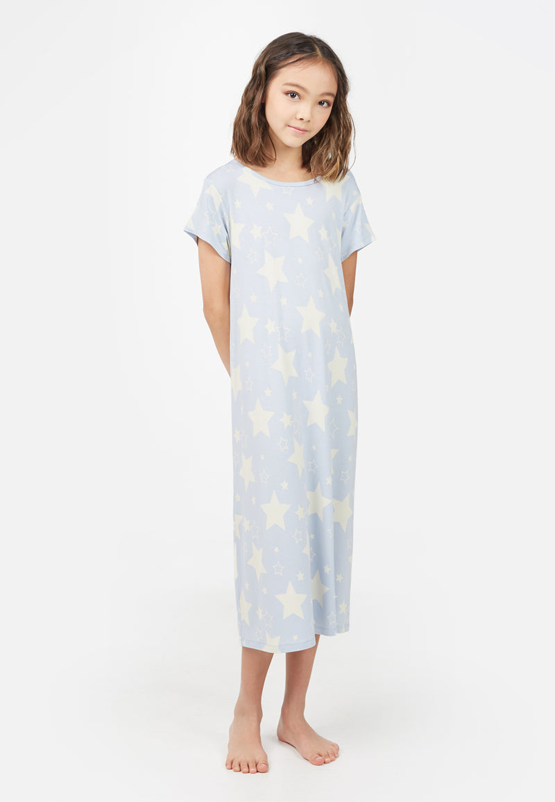 Model wears blue Star Print Girls Oversized Nightdress by Gen Woo. 