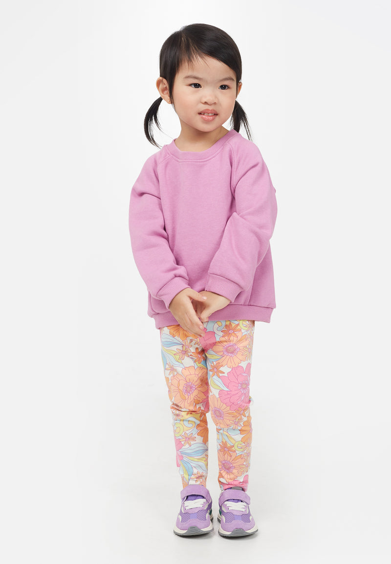 Little girl wears the Apricot and Pink Printed Floral Baby Leggings by Gen Woo