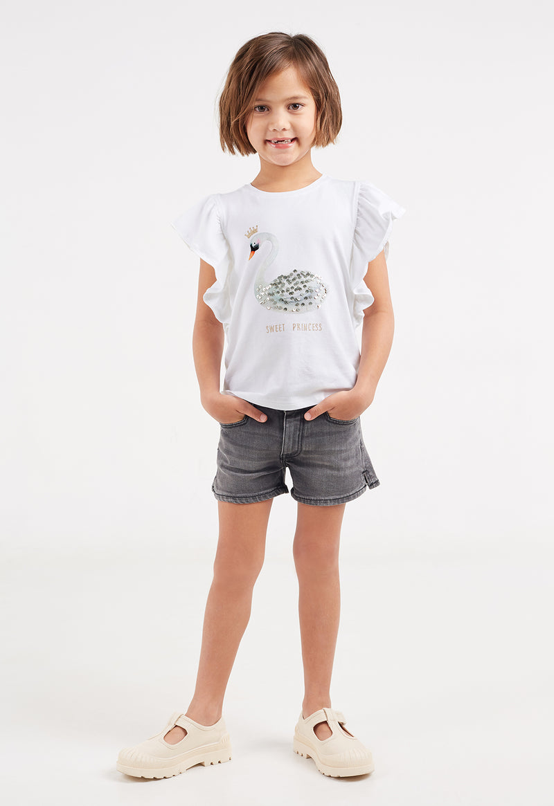 Model wears denim shorts and Girls Swan Princess Frill T-Shirt by Gen Woo.