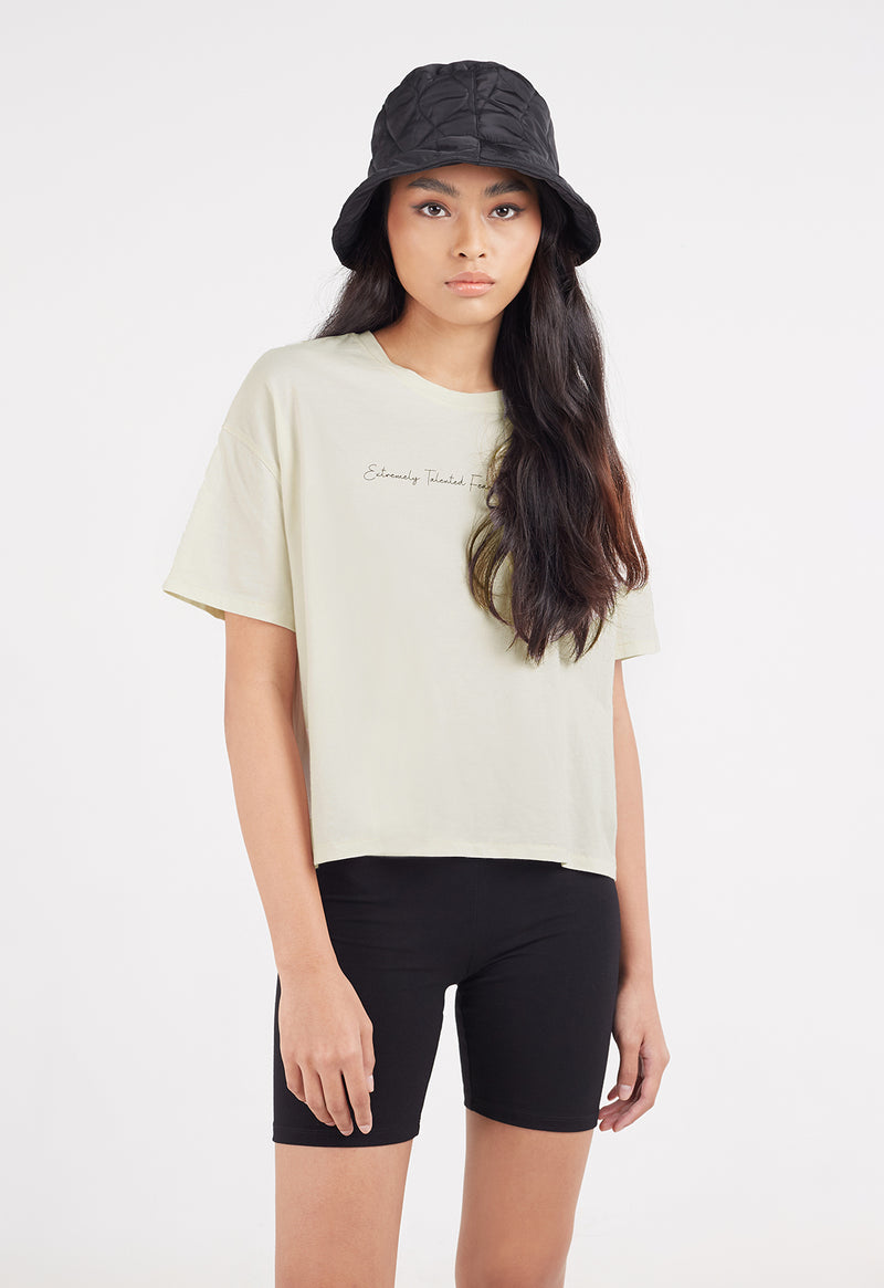 Ladies Tunic by Gen Woo. Our white washed out crop t-shirt features “extremely talented, fearless & strong” slogan print on the front along with a boxy fit. Please note that each washed out garment will have colour shade variation. –Front view