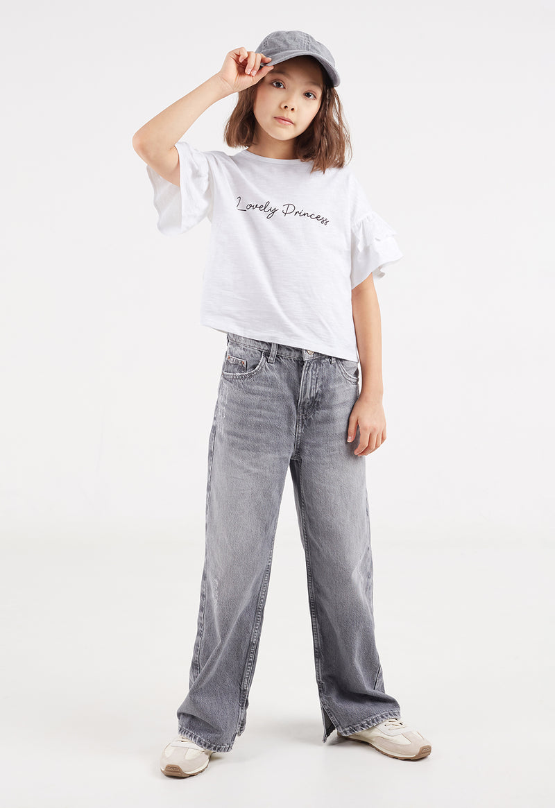 The young girl poses in the “Lovely Princess” Broderie Trim Girls Crop Top by Gen Woo
