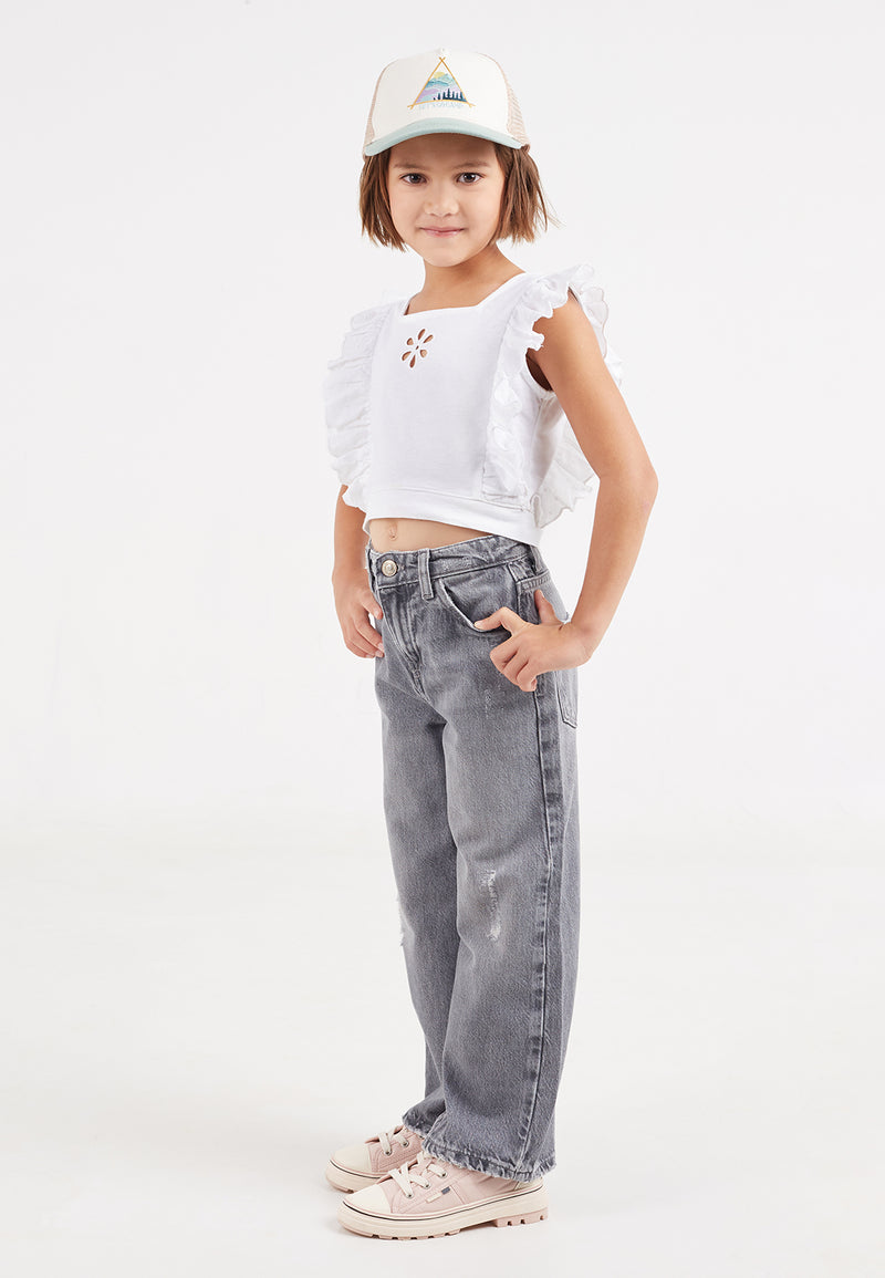 The young girl wears the Broderie Trim Girls Flutter Crop Top by Gen Woo