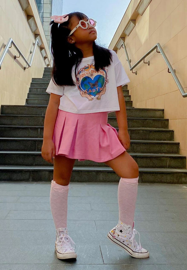 Young girl wears the Begonia Pink Pleated Twill Skort by Gen Woo