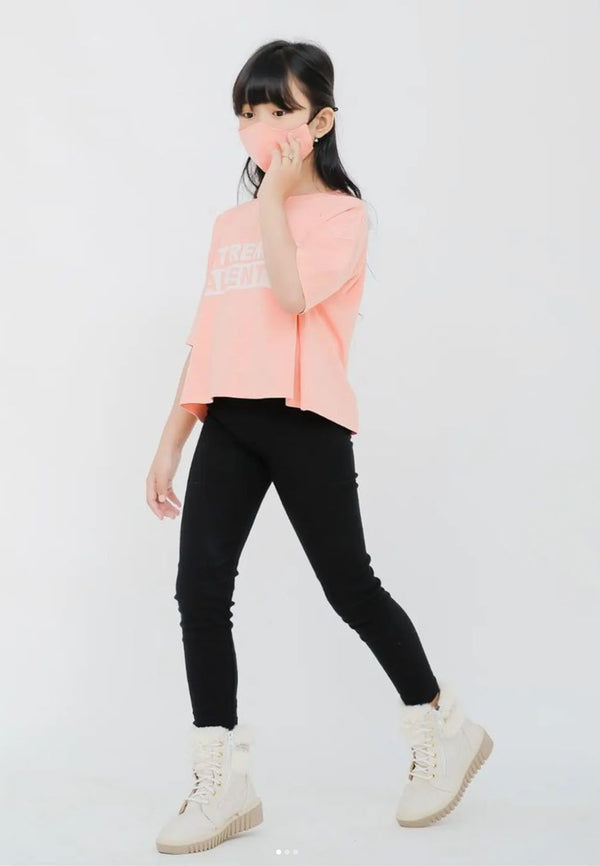 The teen girl wears the Pink “Extremely Talented” Slogan Girls Boxy Cropped T-Shirt by Gen Woo