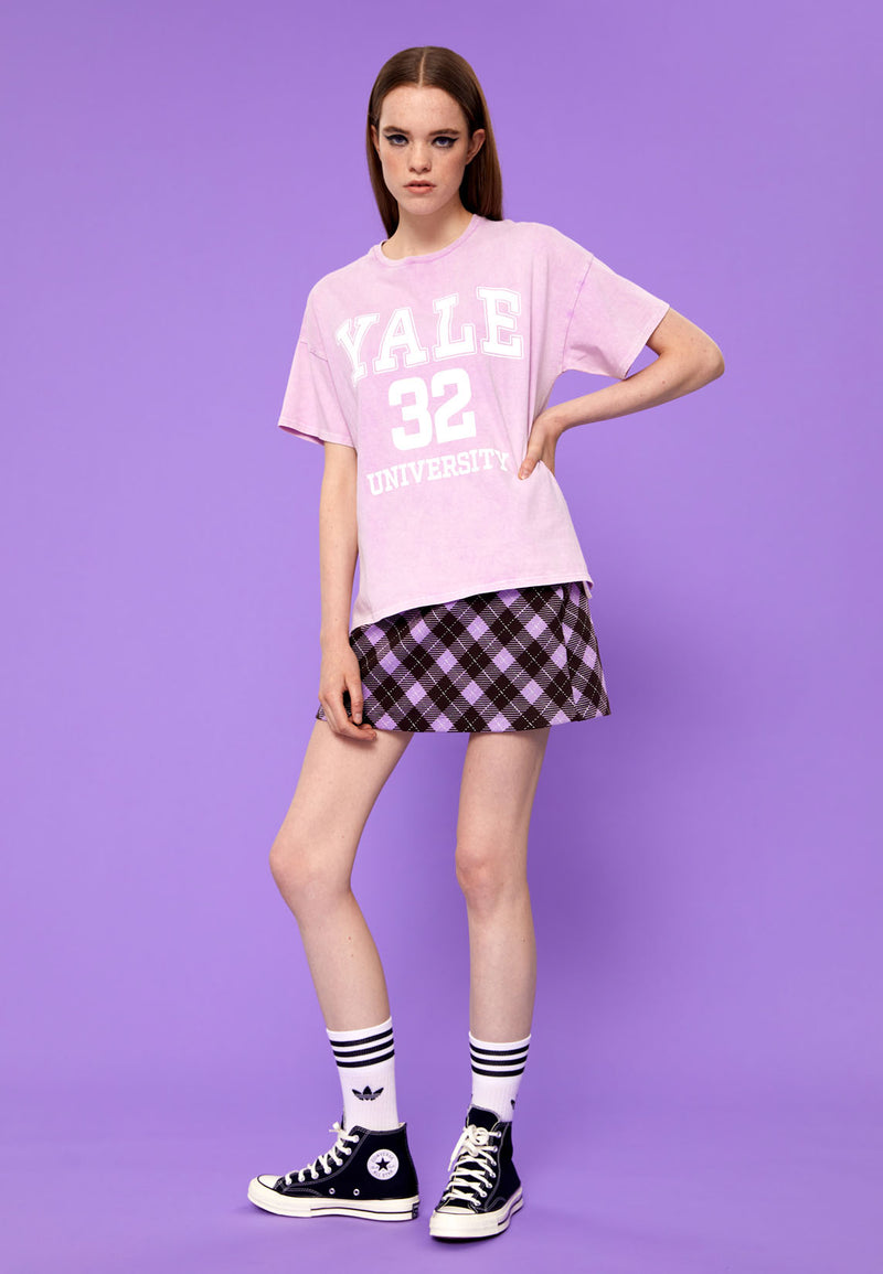 Teenage girl wears the Purple Plaid Girls Mini Skort by Gen Woo