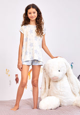 Model wears blue and white Star Print Girls Short Pyjama Set by Gen Woo. 