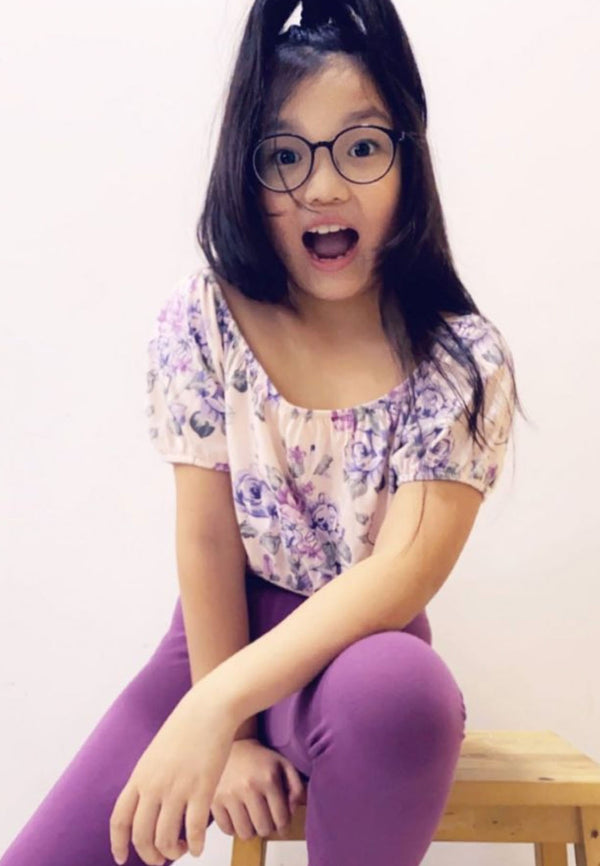The teen girl wears the Purple Cotton-Rich Girls Leggings by Gen Woo